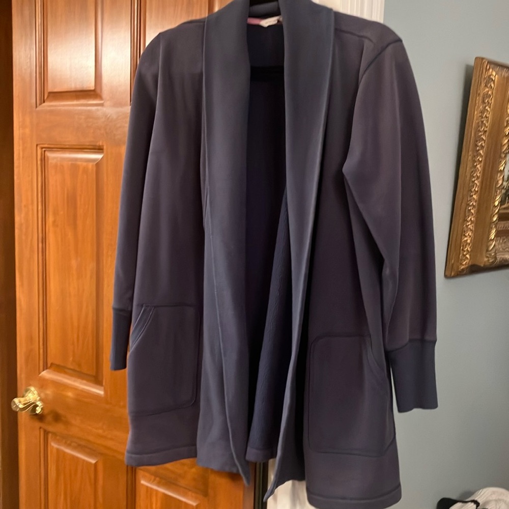 Blue sweatshirt material jacket.  Great to throw over work out clothing. Size M